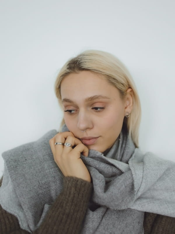 woman with large gray scarf and unique silver jewelry and soft sweater showing style lines for Flamboyant natural 