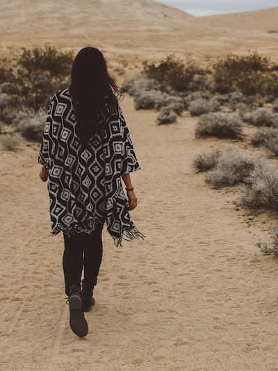 woman walking in dessert with abstract print shawl jacket