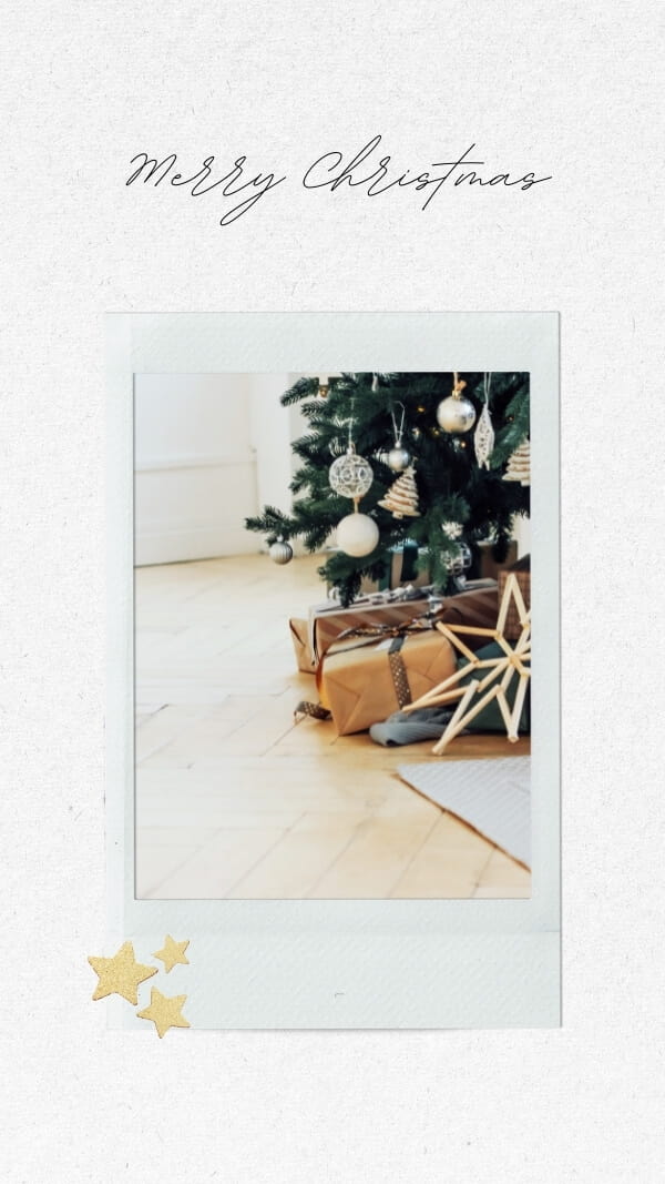 gifts under christmas tree polaroid on white paper background, star stickers in corner with text "merry christmas"