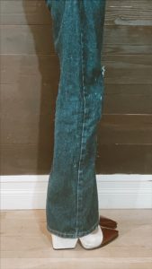 side view/close up view of 32 in inseam wide-leg jeans with heels (they fall about 1 in above ground