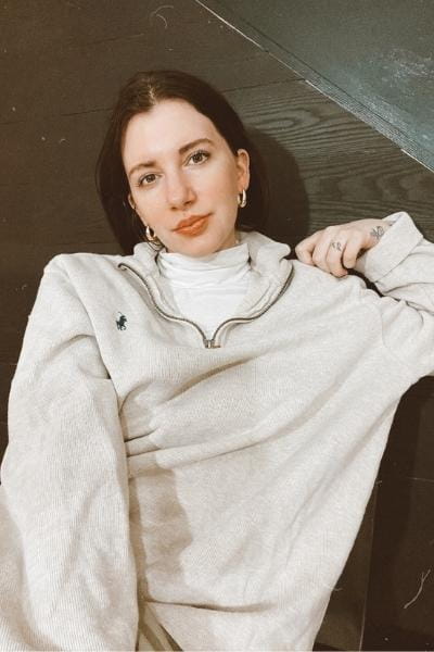 gabrielle arruda wearing a tan half-zip pullover sweater part of winter capsule wardrobe 