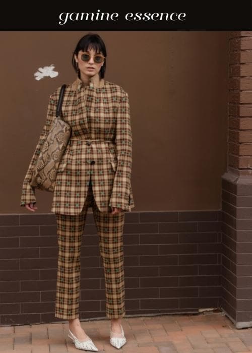 woman wearing a matching plaid suit with quirky accessories to show gamine style essence
