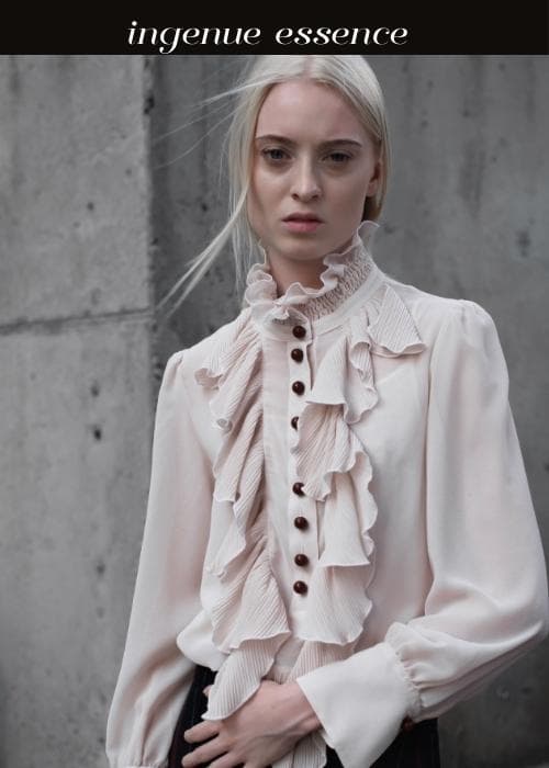 woman with platinum wispy hair wearing frilly high neck blouse- ingenue essence