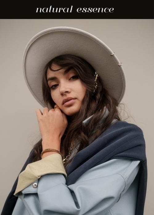 woman wearing oversized jacket with wide brim hat and natural style essence