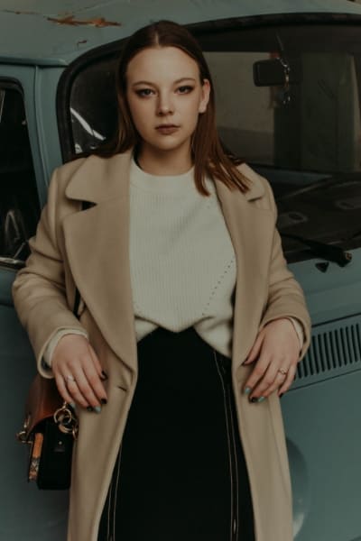 woman wearing wool coat and cashmere sweater in classic fashion style 
