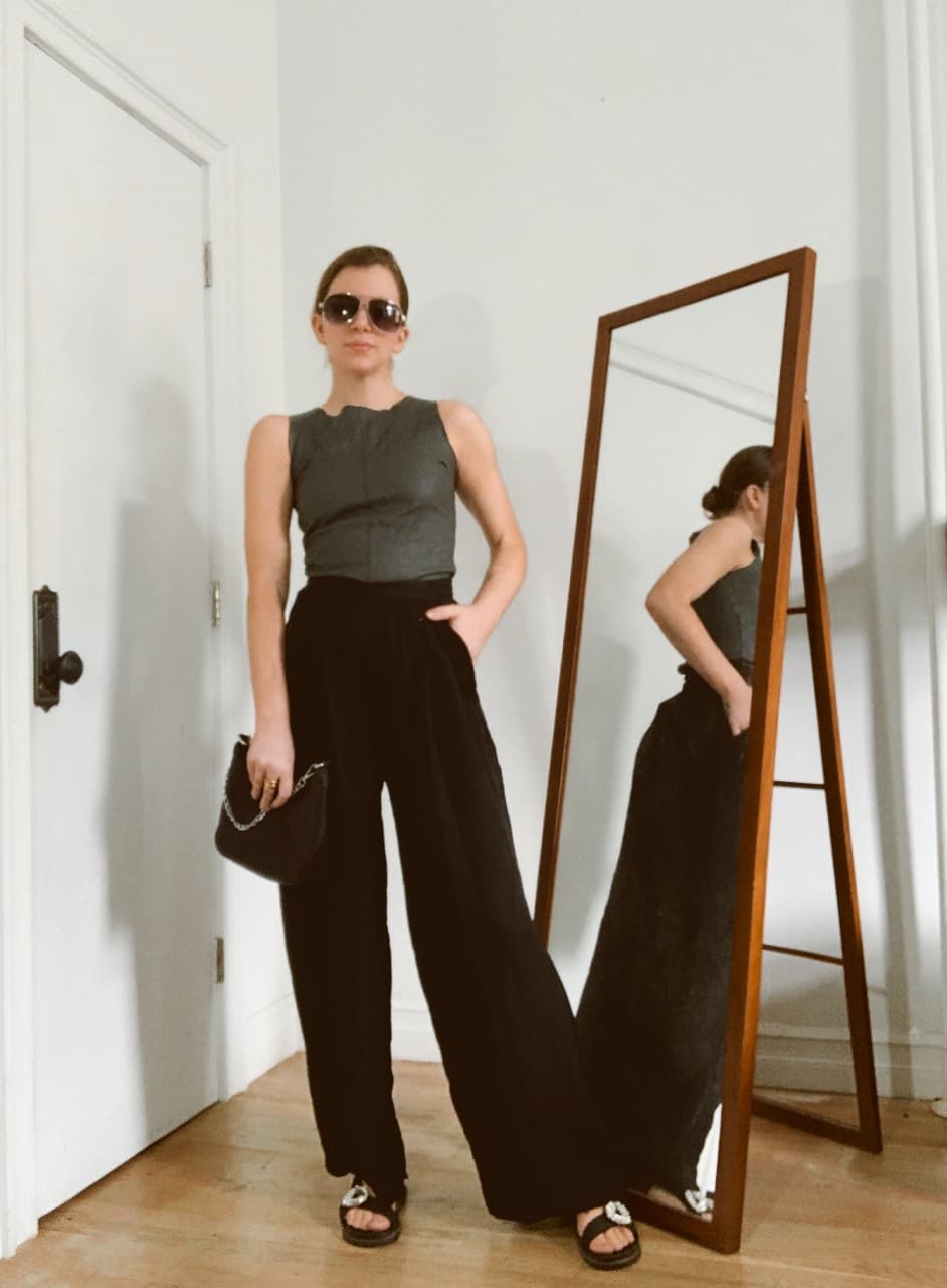 gabrielle arruda wearing black  wide leg jeans with sandals and boatneck leather top for spring capsule