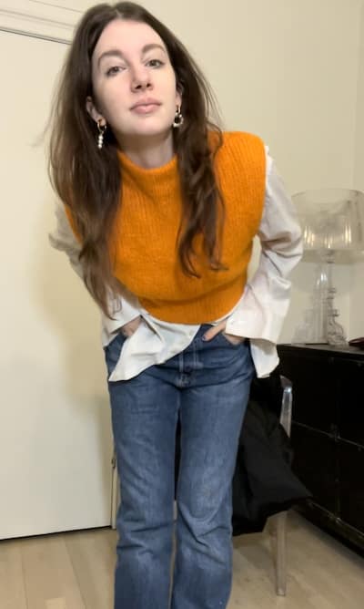 gabrielle arruda in the wrong seasonal color, wearing bright orange sweater that is way too warm for her cool toned skin