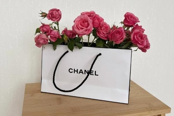 chanel shopping bag with flowers in it